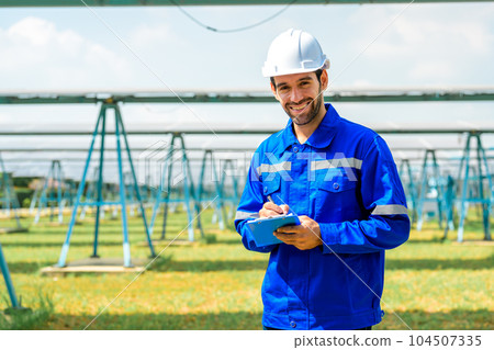 Workers installing solar panels, Engineer team at solar panel farm 104507335