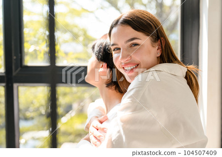 Portrait of happy young couple spending time together at home Portrait of happy young couple spending time together at home 104507409