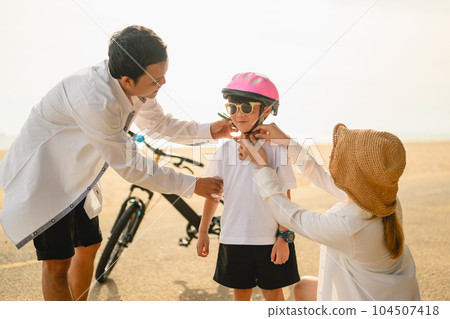 Happy family spending good time with outdoor activities on beach Happy family spending good time with outdoor activities on beach 104507418