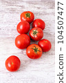 Multiple tomatoes arranged vertically 104507477