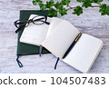 glasses, notebook and pen 104507483