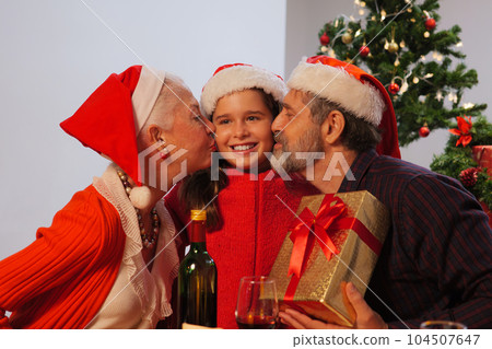 Happy family enjoying with Christmas celebration at home, Excited grandparent happy daughter and family with Christmas present gift box, Merry Christmas and Happy New Year Happy family enjoying with Christmas celebration at home, Excited grandparent happy daughter and family with Christmas present gift box, Merry Christmas and Happy New Year 104507647