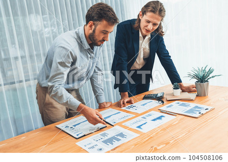 Analyst team in office analyzing financial data analysis papers. Entity Analyst team in office analyzing financial data analysis papers. Entity 104508106
