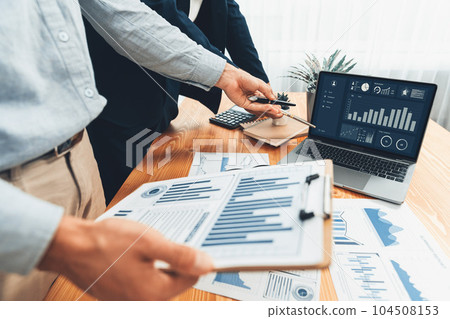Busy analyst team in office analyzing financial data analysis. Entity Busy analyst team in office analyzing financial data analysis. Entity 104508153