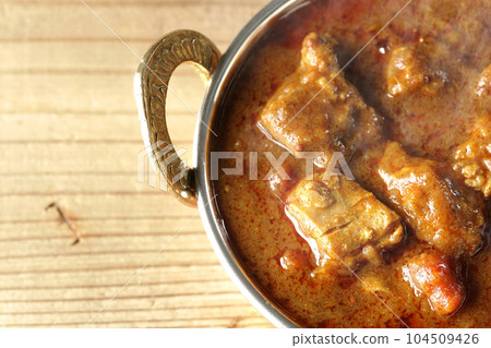 Bird's-eye view of spicy Indian curry with chicken 104509426