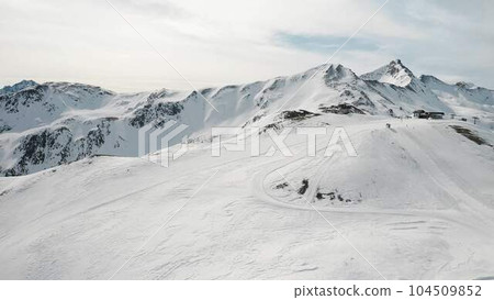 People snowboarding skiing at ski resort. Skiers, snowboarders riding snowy mountain  104509852
