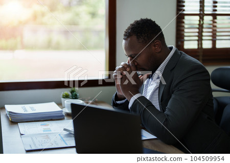 Burnout American African business man in stress works with many paperwork document, migraine attack, Freelance, work from home. Burnout American African business man in stress works with many paperwork document, migraine attack, Freelance, work from home. 104509954