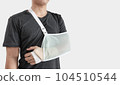 Young man with hand injured wearing splint, broken arm, isolated on white background 104510544