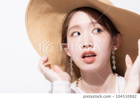 Beauty Summer Portrait of a woman wearing a straw hat 104510882