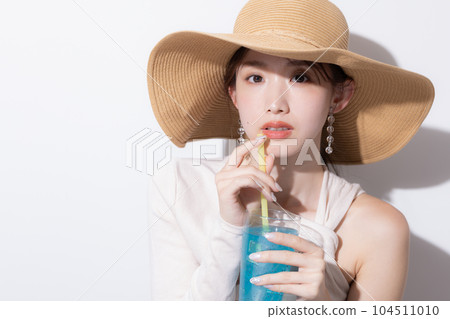 Beauty Summer Portrait of a woman drinking tropical juice Beauty Summer Portrait of a woman drinking tropical juice 104511010