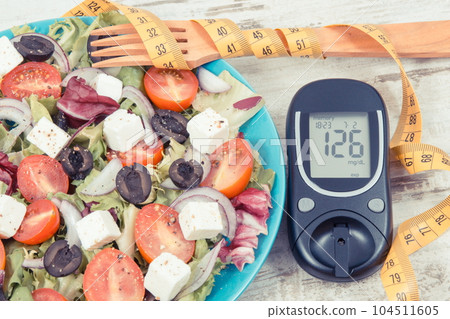 Glucometer for checking sugar level, tape measure and fresh greek salad Glucometer for checking sugar level, tape measure and fresh greek salad 104511605