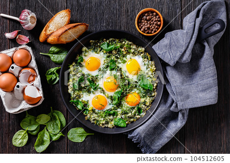 green shakshuka in frying pan, top view 104512605