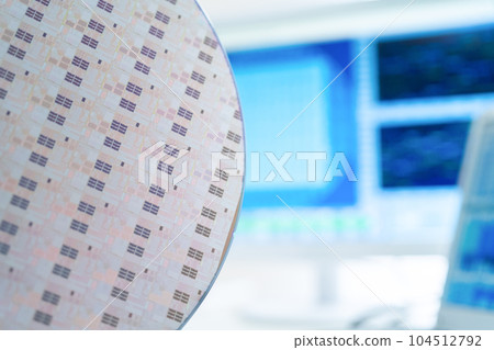 Engineer inspecting wafers in clean room 104512792