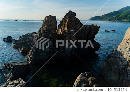 Rocks on the seashore at dawn. Rocks on the seashore at dawn. 104513354