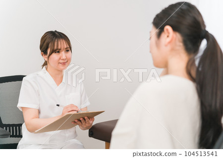 Counseling woman in white coat (nurse, counselor, esthetician) Counseling woman in white coat (nurse, counselor, esthetician) 104513541