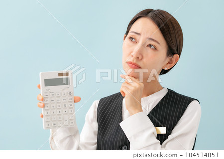 A woman in a uniform who is troubled with a calculator 104514051