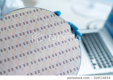 Engineer inspecting wafers in clean room Engineer inspecting wafers in clean room 104514654