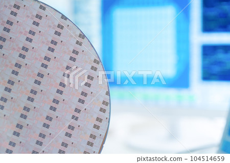 Engineer inspecting wafers in clean room 104514659