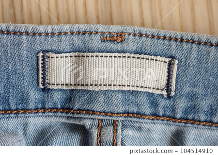 blank clothes label on blue jeans denim background 104514910