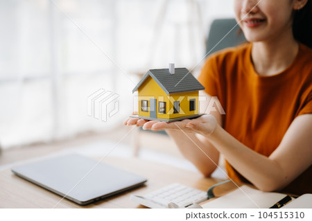 Considering buying a home, investing in real estate. Broker signs a sales agreement. agent, lease agreement, successful deal in office. Considering buying a home, investing in real estate. Broker signs a sales agreement. agent, lease agreement, successful deal in office. 104515310
