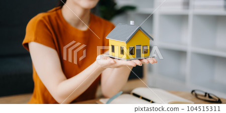 Considering buying a home, investing in real estate. Broker signs a sales agreement. agent, lease agreement, successful deal  in office. 104515311