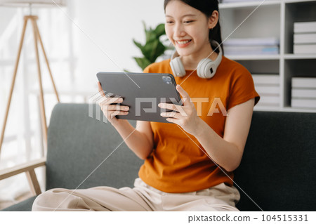 Woman hand using a laptop, smartphone and tablet and writing notebook at the office of her business online shopping. In home 104515331