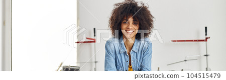 Portrait of smiling African-American woman with mobile phone lea Portrait of smiling African-American woman with mobile phone lea 104515479