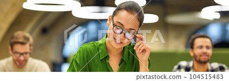 Never stop learning. Focused asian woman wearing eyeglasses making some notes while studying with colleagues during corporate training or seminar Never stop learning. Focused asian woman wearing eyeglasses making some notes while studying with colleagues during corporate training or seminar 104515483