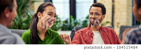 Young cheerful asian business woman discussing project results with colleagues while working together in the modern office Young cheerful asian business woman discussing project results with colleagues while working together in the modern office 104515484