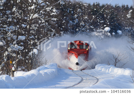 The Russell locomotive pushes off the accumulated snow with the railway snow forest in the background The Russell locomotive pushes off the accumulated snow with the railway snow forest in the background 104516036