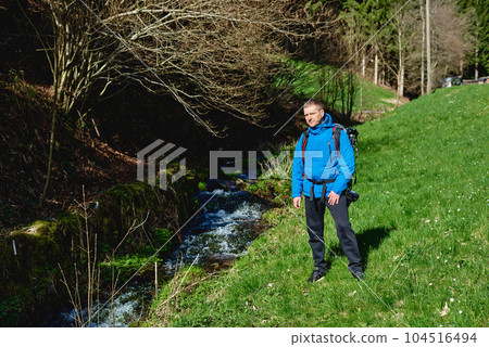 Man hiking at sunset mountains with heavy backpack Travel Lifestyle wanderlust adventure concept summer vacations outdoor alone into the wild. Hipster man traveler wanderer wearing travelling alone Man hiking at sunset mountains with heavy backpack Travel Lifestyle wanderlust adventure concept summer vacations outdoor alone into the wild. Hipster man traveler wanderer wearing travelling alone 104516494