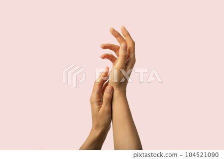 Beauty hands gently touching soft moisturized skin on pink background Beauty hands gently touching soft moisturized skin on pink background 104521090