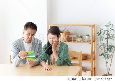 Senior couple looking at the passbook 104521536