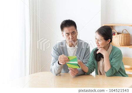 Senior couple looking at the passbook Senior couple looking at the passbook 104521543