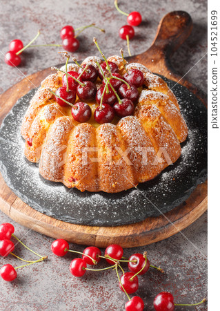 Freshly baked cherry cake close-up on a wooden board. Vertical Freshly baked cherry cake close-up on a wooden board. Vertical 104521699