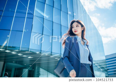 Business woman walking in the city (AI generated) 104521733