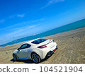 Sea, sandy beach and sports car 104521904