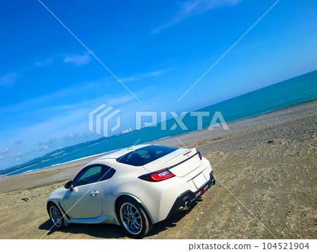 Sea, sandy beach and sports car 104521904
