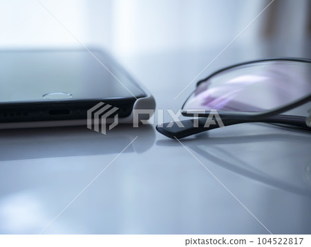 glasses and smartphone on the table glasses and smartphone on the table 104522817