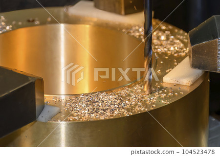 The drilling process on NC milling machine with brass material. 104523478