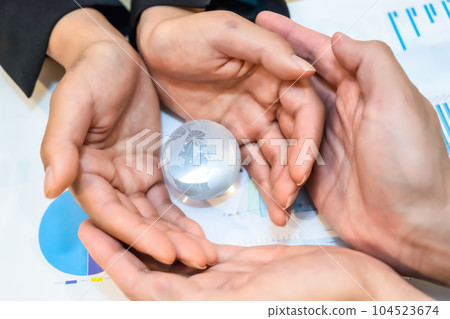 globe crystal and businessman and businesswoman 104523674