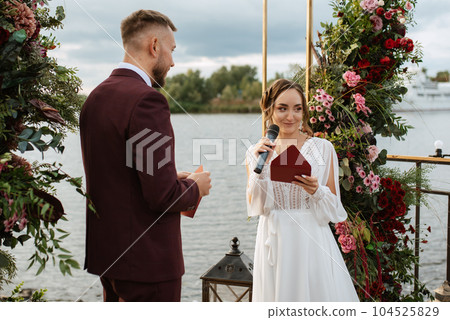 wedding ceremony of the newlyweds on the pier 104525829