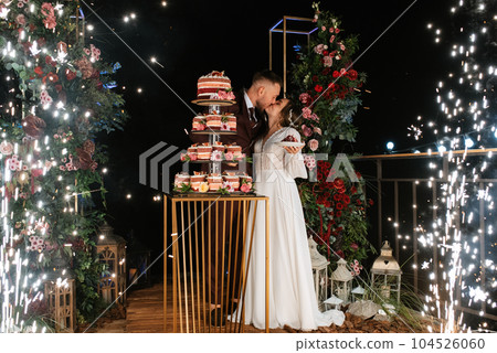 newlyweds happily cut and taste the wedding cake newlyweds happily cut and taste the wedding cake 104526060