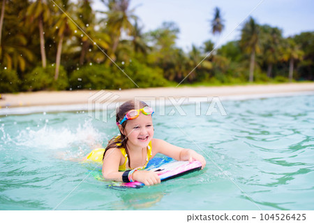 Kids playing on beach. Children play at sea. Kids playing on beach. Children play at sea. 104526425