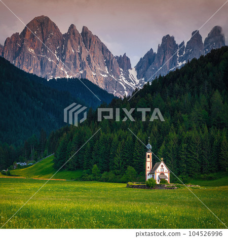 St Johann church on the green field, Dolomites, Italy 104526996