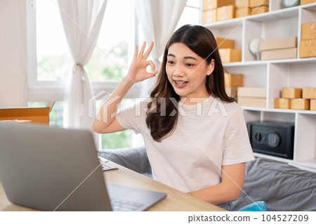 Entrepreneurial Woman Takes Selfies with Products for Online Sales, Working from Home, Identity Verification and Order Confirmation in Online Business, Capturing the Essence of Entrepreneurship. 104527209