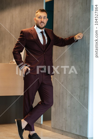 portrait of smiling groom with beard 104527864