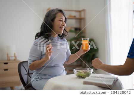 Two asian elderly woman enjoy eating healthy food at house Two asian elderly woman enjoy eating healthy food at house 104528042
