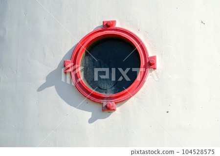 A round window with red edges. Lighthouse on the Estonian island of Kihnu A round window with red edges. Lighthouse on the Estonian island of Kihnu 104528575