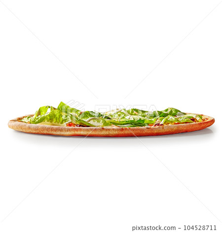 Thin pizza with browned edge topped with lettuce and cream cheese sauce Thin pizza with browned edge topped with lettuce and cream cheese sauce 104528711